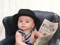 baby reading newspaper